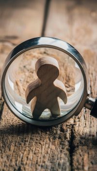 marketing-analysis-concept-with-magnifying-glass-wooden-figure-wooden-grunge-background